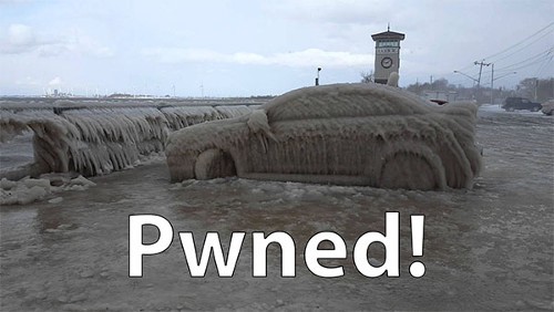 Car surrounded by water and covered in ice