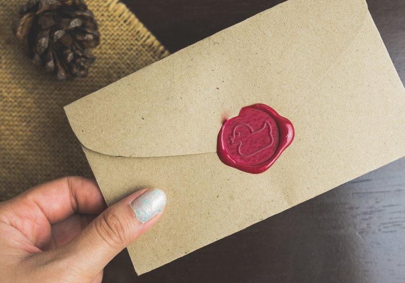 Unopened wax seal on the back of an envelope.